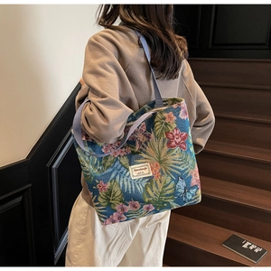 Detail of vintage style floral tapestry tote bag with blue butterfly and leaf embroidery