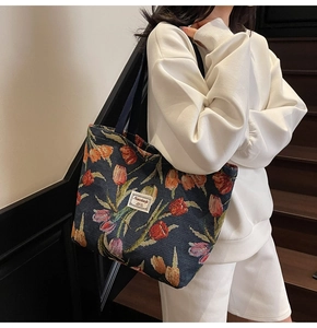 Detailed close-up of a vintage floral jacquard tote bag with vibrant tulip embroidery