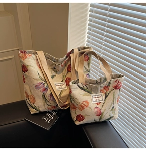 Detailed view of two jacquard floral tote bags with tulip patterns in a retro indoor setting