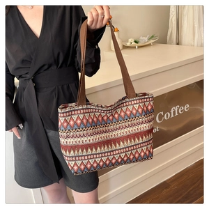 Ethnic tote bag detail with colorful geometric patterns and durable brown shoulder strap