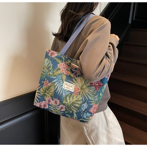 Detail of floral canvas tote bag with tropical embroidery and durable woven straps