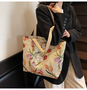 Detail of vintage French jacquard tote bag with red tulip floral patterns and cotton straps