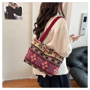 Ethnic printed canvas tote bag worn over the shoulder showing large capacity design