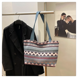Detailed shot of ethnic geometric pattern canvas tote bag hanging on a minimalist rack
