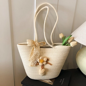 Handcrafted woven tote bag with lace bow and floral charm decoration in cream white