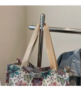 Detail of vintage floral jacquard tote bag showing durable beige woven shoulder strap