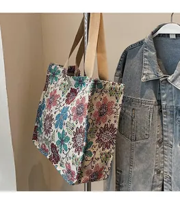 Detail of vintage floral jacquard tote bag featuring premium woven texture and beige straps