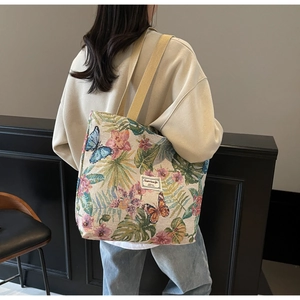 Detail of vintage floral butterfly jacquard pattern on large capacity canvas tote bag