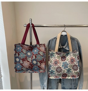 Detail of heavy jacquard tote bags with vintage floral patterns and sturdy handles