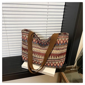 Close-up of geometric diamond woven patterns and durable wide shoulder strap on tote bag