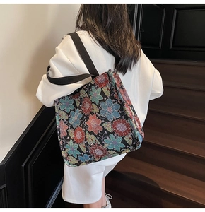 Detailed close-up of ethnic style jacquard tote bag with colorful floral embroidery