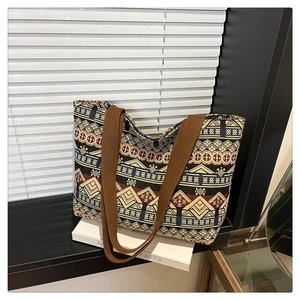Detail of ethnic geometric canvas tote bag with woven straps on a minimalist background