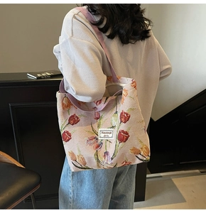 Detail of tulip jacquard fabric texture and woven label on a large capacity tote bag