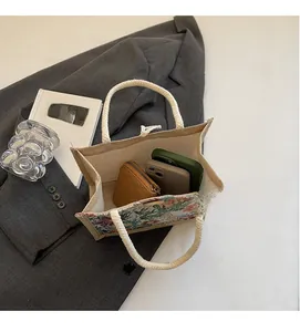 Internal view of linen tote bag showing capacity for phone and wallet with embroidery