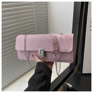 Detail of pink glitter square handbag featuring silver S-curve clasp and chain strap