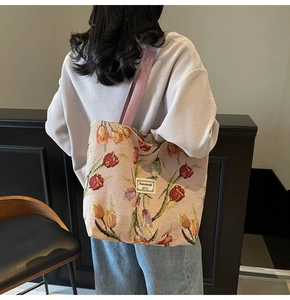 Detailed back view of a large tote bag with pink tulip patterns and wide shoulder strap