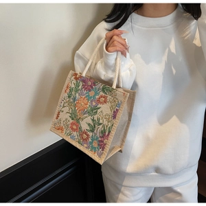 Detailed shot of floral linen lunch bag with colorful patterns and durable rope handles