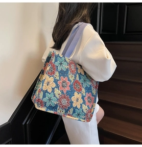 Detailed view of an ethnic jacquard tote bag with vibrant flower patterns and purple strap