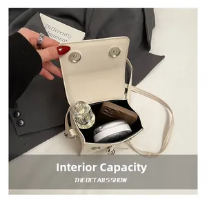 Detail showing the internal capacity of the cream crossbody bag for daily essentials