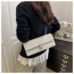 Detail of silver sequin square bag with metal chain strap and luxury square buckle