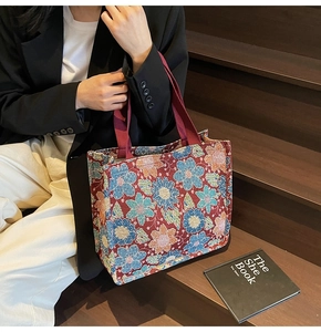 Lifestyle shot of large capacity ethnic tote bag with colorful floral embroidery