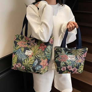 Floral tapestry tote bag set in deep blue with intricate botanical patterns and woven labels