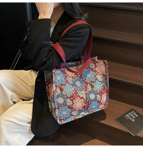 Detail shot of vintage floral jacquard tote bag featuring a textured tapestry pattern