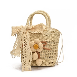 Handmade woven beach bag with lace bow and floral charm in beige straw texture