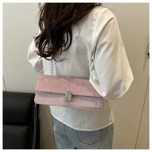 Detail of pink sequin rectangular shoulder bag with silver chain strap and metal clasp