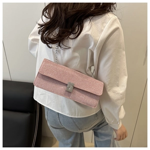 Detail of pink glitter rectangular chain bag with silver twist lock and slim metal strap