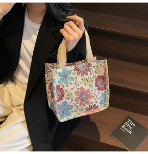 Close-up of vintage floral tapestry tote bag with textured jacquard knit pattern