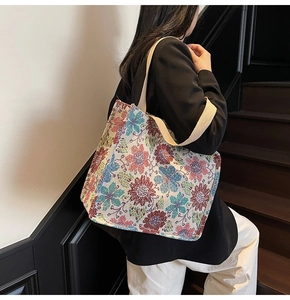 Detailed texture of large ethnic floral jacquard tote bag with woven carry handles