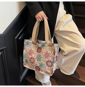 Detail of floral jacquard tote bag with ethnic pattern and khaki webbing handles