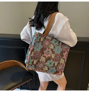 Detailed view of ethnic floral tapestry tote bag with durable canvas shoulder strap