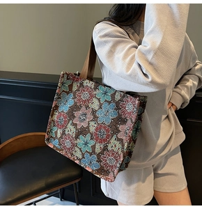 Detailed view of colorful floral jacquard pattern and texture on a large tote bag