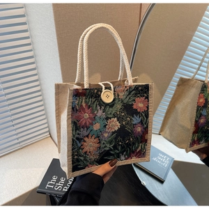 Detailed shot of vintage floral tapestry tote bag with rope handles and button closure