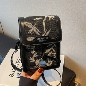 Vertical mini crossbody bag with leaf jacquard fabric and black leather trim accents