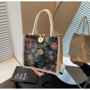 Close-up of vintage floral linen tote bag with jacquard pattern and large button closure