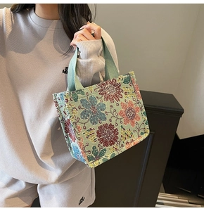 Close-up of floral embroidery texture and jacquard fabric on a large tote bag