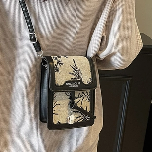 Vertical small canvas crossbody bag with leaf print and black leather trim for women