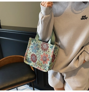 Detail of ethnic jacquard tote bag featuring vibrant floral weaving and sturdy handles