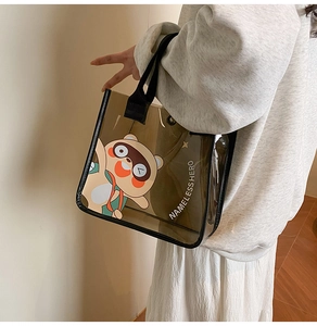 Gros plan d'un sac cabas transparent marron avec motif tanuki et anses noires