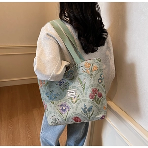 Side view of floral canvas tote bag on model showing size and jacquard texture