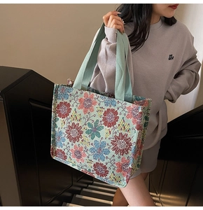 Detail of colorful jacquard floral tote bag with high-density light green woven handles