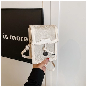 Detail of floral jacquard embroidery on cream crossbody phone bag with brand logo