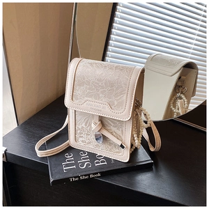Detail of off-white crossbody phone bag with floral embossing and pearl chain strap
