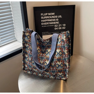 Close-up of bohemian geometric jacquard tote bag with blue heavy-duty fabric handles
