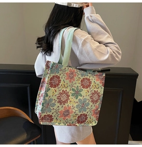 Detail of vintage floral jacquard tote bag with reinforced handles and ethnic pattern