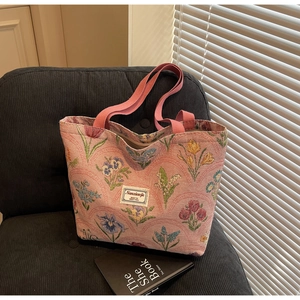 Close-up of floral jacquard canvas tote with tulip patterns and woven texture