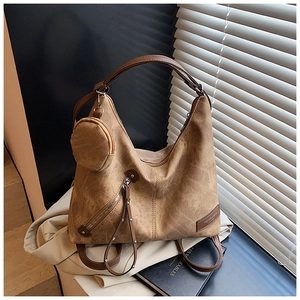 Close-up of brown suede tote bag with detachable mini coin purse and metal side zipper
